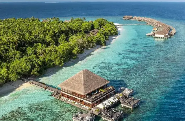 Maldives island resort with turquoise lagoon and overwater villas