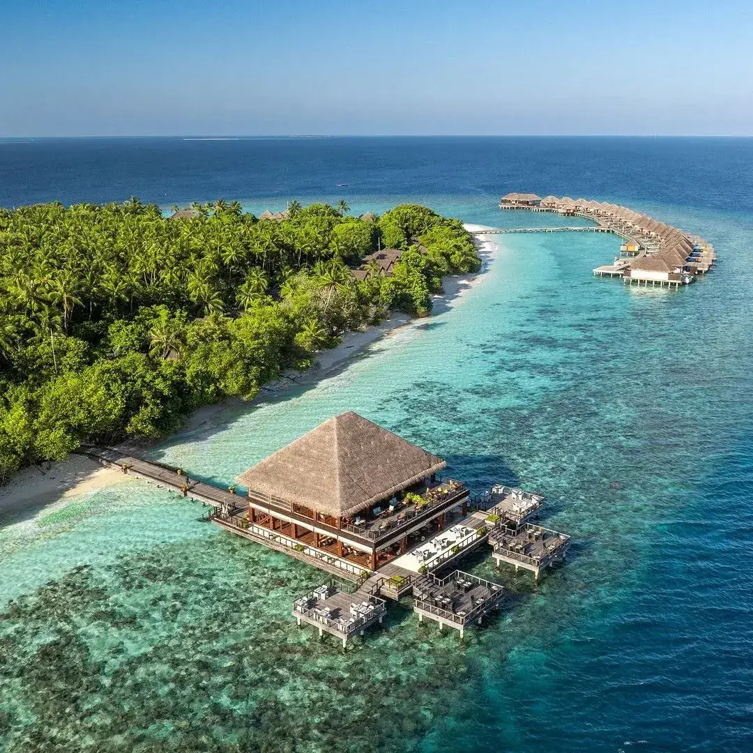 Maldives island resort with turquoise lagoon and overwater villas